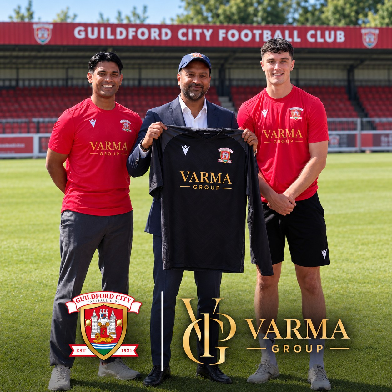 Sree Varma holding a black Guildford City FC shirt with the Varma Group logo, flanked by two players in red Varma Group training tops at the club's stadium